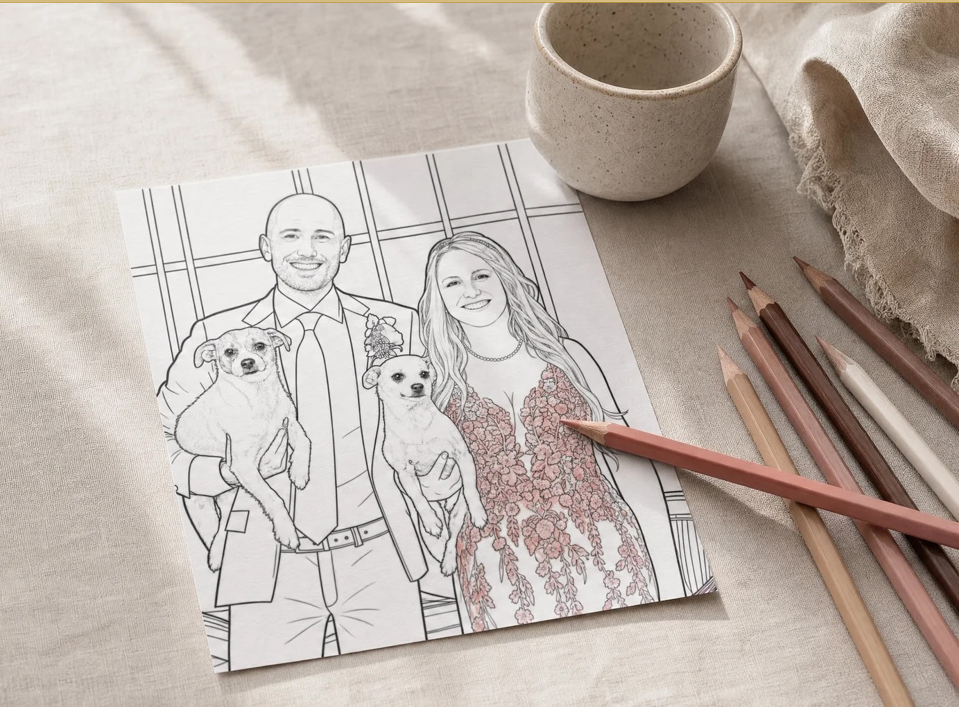 Custom coloring page of a couple holding two dogs, on a linen table with pencils